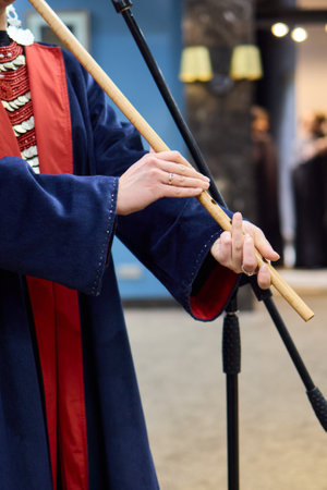 A skilled musician dressed in beautiful traditional attire is playing a bamboo fluteの写真素材