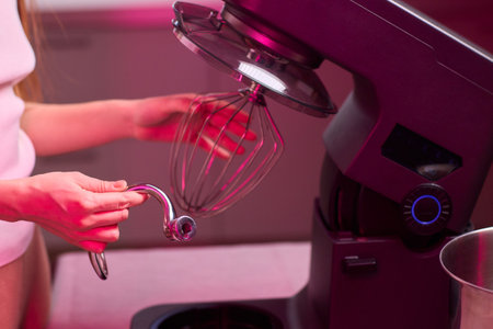 A Modern Kitchen Mixer is Actively in Use for Whipping Up Delicious Baking Creationsの写真素材