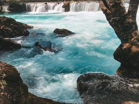 Serene Aqua Flow A Tranquil River Scene with Cascading Waterfalls for Relaxationの写真素材