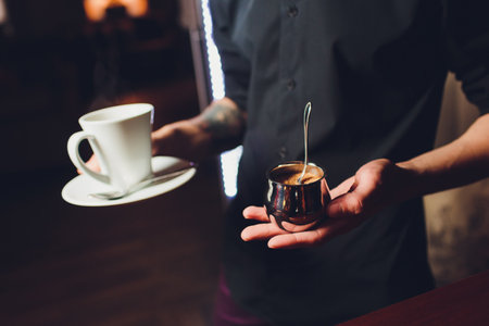 A Stacked Arrangement of White Teacups on a Table, creating a warm and elegant atmosphereの写真素材