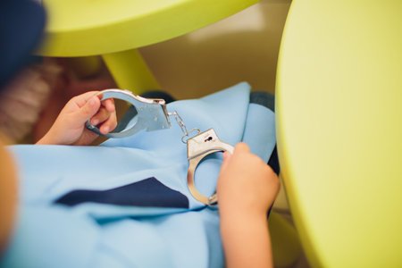 A Child Happily Playing with Colorful Toys on a Brightly Colored Table Surfaceの写真素材