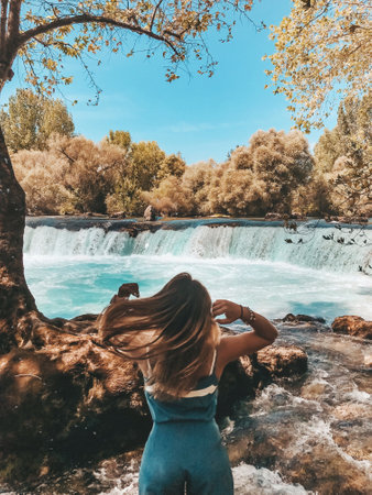 Serene Aqua Flow A Tranquil River Scene with Cascading Waterfalls for Relaxationの写真素材