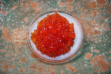 Delicious salmon roe on a white plate, perfect as an appetizer or gourmet brunch dishの写真素材