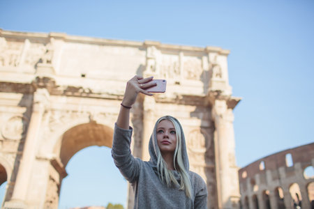 A Stylish Woman Taking Time to Relax in a Beautiful Historic Roman Landscape Settingの写真素材
