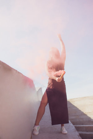 A Stylish Woman Exuding Elegance with a Pink Smoke Bomb in Her Fashionable Attire Ensemble