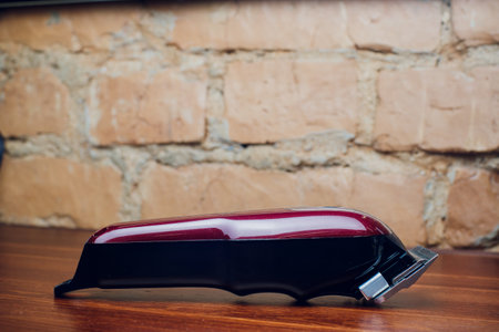 An Electric Hair Removal Device showcases its design elegantly on a stylish wooden surface