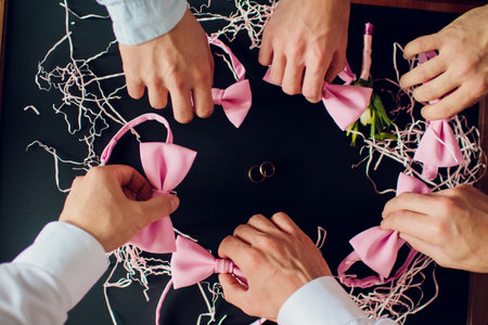 Engaging and Creative Wedding Preparations with Charming Pink Bows and Elegant Rings
