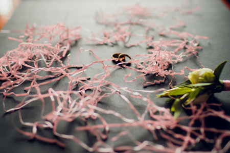An Elegant Setup Featuring Pink Bow Ties and Wedding Rings for Memorable Celebrations
