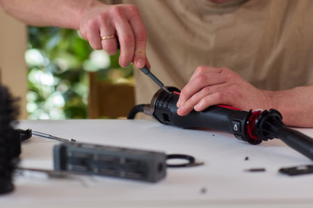 Hands of skilled workers diligently engaged in the intricate repair of mechanical devices