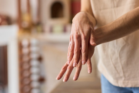 A gloved hand prepares to perform a care procedure safely and professionally in healthcareの写真素材