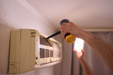 Hands are Actively Engaged in Various Tasks such as Air Conditioning Repair and Ongoing Maintenanceの写真素材