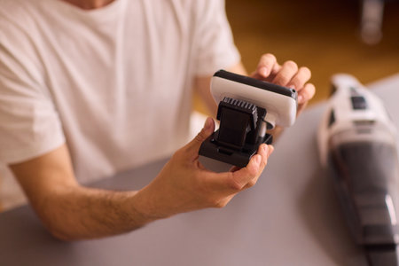 Unboxing a brand new handheld vacuum cleaner attachment, perfect for efficient cleaning tasksの写真素材