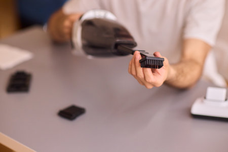 Unboxing a brand new handheld vacuum cleaner attachment, perfect for efficient cleaning tasksの写真素材