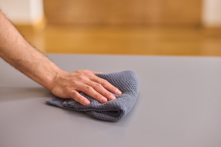 Performing the task of cleaning surfaces with a cloth for a fresh and polished look