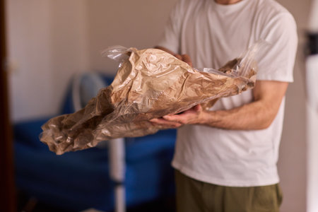 A Man Unpacking Materials in a Modern, Stylish, and Organized Environmentの写真素材