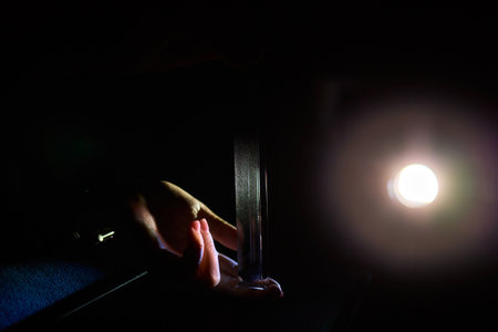 An engaging Light Refraction Experiment using a Prism and the interaction of handsの写真素材