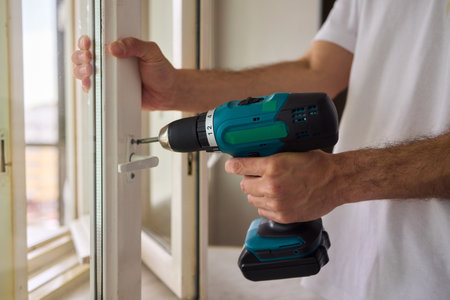 Engaging in DIY Home Improvement Projects with a Power Drill in a Stylish Modern Apartment