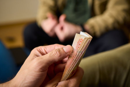 A Cash Transaction That Carries Unsettling and Uneasy Undertones of Tension and Anxietyの写真素材