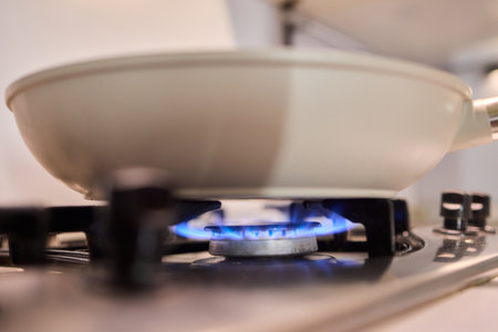 Bright Blue Flame Emanating from a Gas Burner in a Kitchen Setting Suitable for Cookingの写真素材