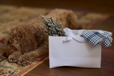 An Elegant Gift Box beautifully adorned with a Green Design and complemented by White Handlesの写真素材