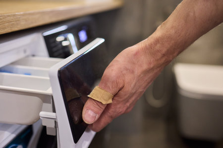 A person is effortlessly using their hand to open the drawer of a contemporary modern refrigeratorの写真素材