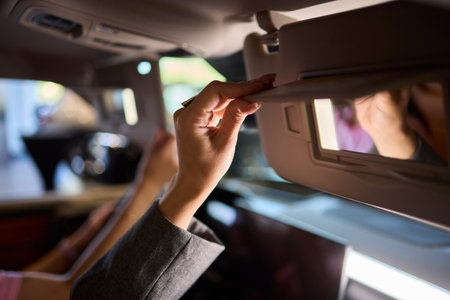 The modern car interior features a sleek vanity mirror that highlights both functionality and styleの写真素材