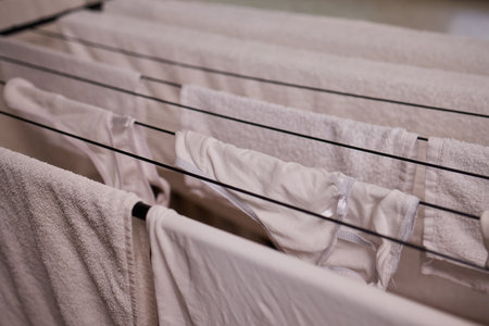 Arranging Freshly Laundered Towels Neatly on a Drying Rack for Optimal Drying and Organizationの写真素材