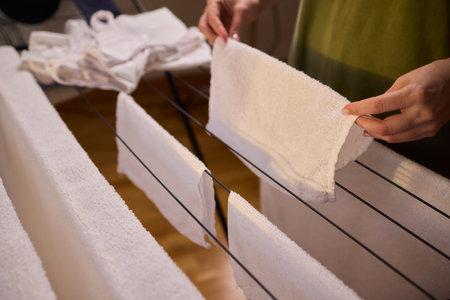 Arranging Freshly Laundered Towels Neatly on a Drying Rack for Optimal Drying and Organization
