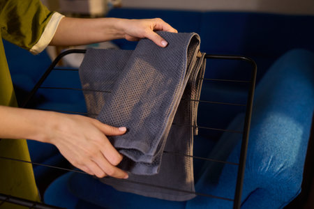 Arranging Freshly Laundered Towels Neatly on a Drying Rack for Optimal Drying and Organizationの写真素材