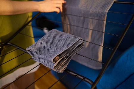 Arranging Freshly Laundered Towels Neatly on a Drying Rack for Optimal Drying and Organizationの写真素材