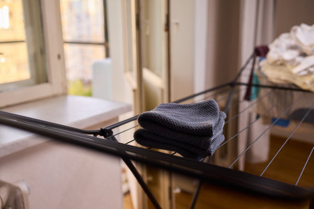 Arranging Freshly Laundered Towels Neatly on a Drying Rack for Optimal Drying and Organizationの写真素材