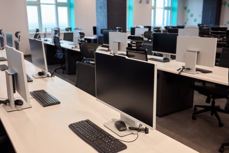A contemporary office workspace designed with modern computers and elegant desks for professionals