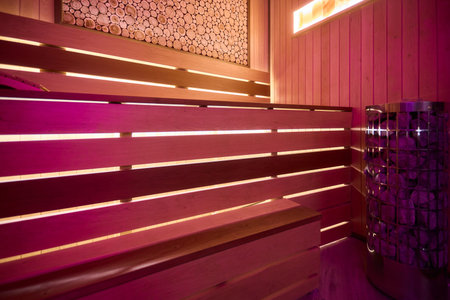 Experience the Cozy Wooden Sauna Interior Equipped with Inviting Warm Lighting and Ambianceの写真素材