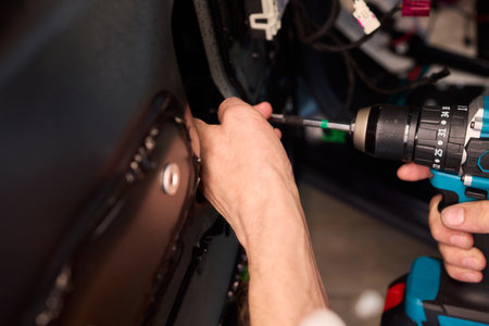 Hands Engaged in the Process of Performing Automotive Interior Repairs Effectivelyの写真素材