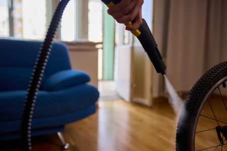 Effectively Cleaning a Bicycle Using a Vacuum Cleaner in a Contemporary Living Room Spaceの写真素材
