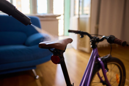 Effectively Cleaning a Bicycle Using a Vacuum Cleaner in a Contemporary Living Room Spaceの写真素材