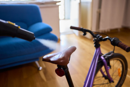 Effectively Cleaning a Bicycle Using a Vacuum Cleaner in a Contemporary Living Room Spaceの写真素材