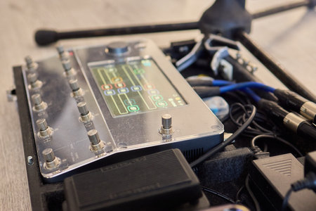 A Unique Collection of Guitar Effects Pedals Carefully Arranged on an Effect Boardの写真素材