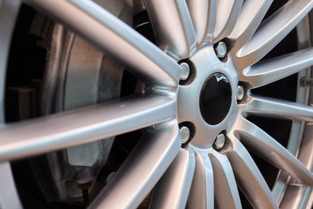An Up Close View of a Stylish and Contemporary Car Wheel Featuring a Sporty Caliperの写真素材