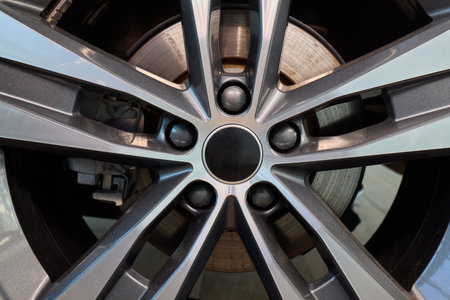 Detailed shot of a sleek black and silver alloy wheel on a motor vehicleの写真素材