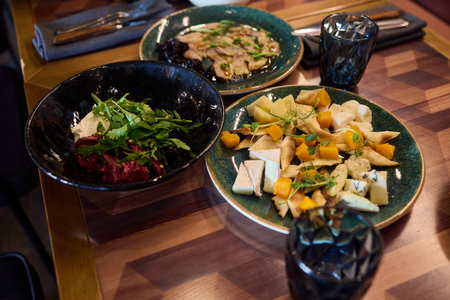 A gourmet dish with bread and fresh, flavorful ingredients elegantly arranged on a plate