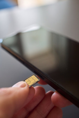Detailed Process of Installing a SIM Card Utilizing Various Smartphone Components and Accessoriesの写真素材