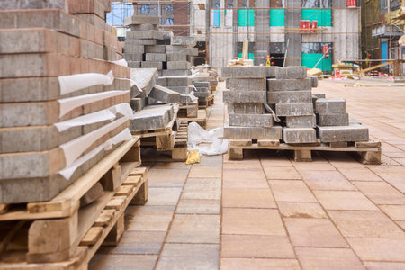 There are numerous piles of concrete debris observable at the busy construction site right nowの写真素材