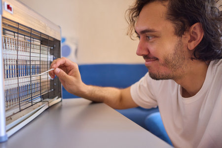 Operating a handheld UV light device specifically designed for killing insects effectivelyの写真素材