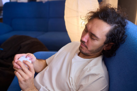 Close-up of an electric nail clipper in hand, modern personal care technology, highlighting compact design and functionality, modern gadget for personal groomingの写真素材