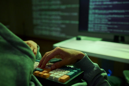 Cybersecurity Analyst Engaged in Writing Code Within a Dimly Lit Environment for Efficiency
