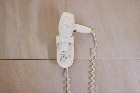 electric hair dryer in hotel bathroom