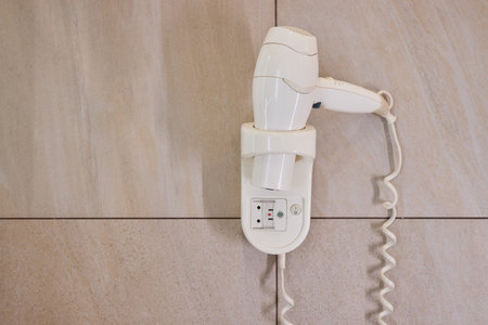 electric hair dryer in hotel bathroomの写真素材
