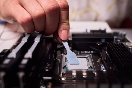 Carefully applying thermal paste on the CPU is essential for achieving optimal cooling performanceの写真素材