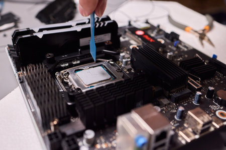 Carefully applying thermal paste on the CPU is essential for achieving optimal cooling performanceの写真素材